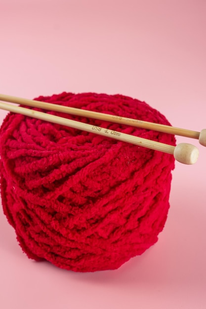 Benang rajut Knitting yarn balls and knitting needles on pink background Knitting concept