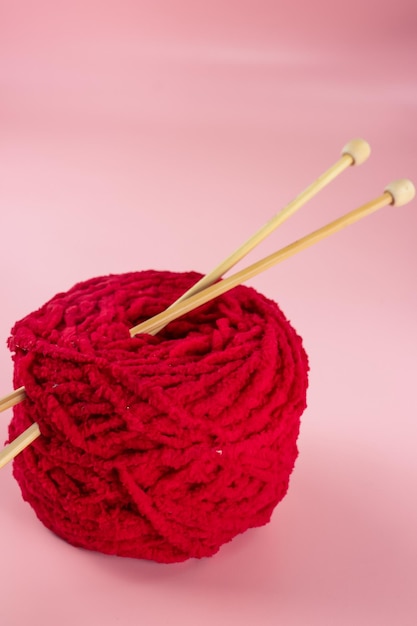 Premium Photo  Large knitting needles are stuck in a large ball