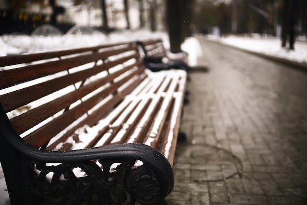 bench in a cold winter park snow