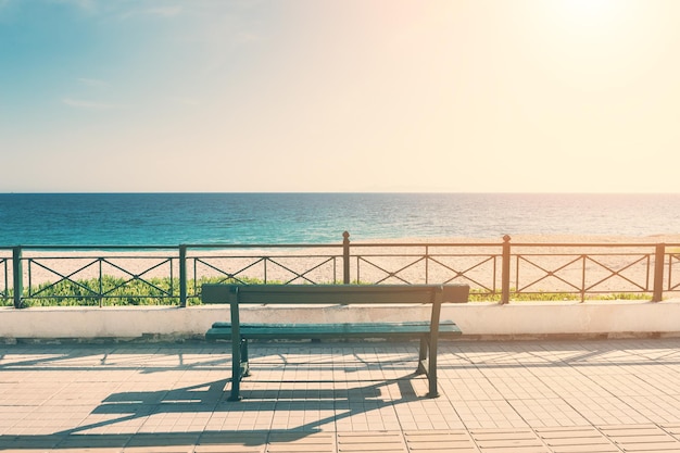 Bench on the sea promenade in Athens, Greece. Vintage filter, retro effect