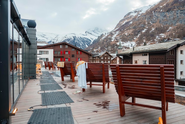 Benches in front of luxurious hotels with swiss alps in background