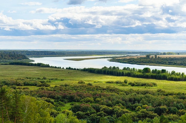 A bend of Beautiful river Tom flowing through autumn valley surrounded by Siberian forest Russia