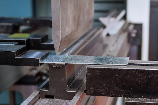 Photo bending sheet metal with a hydraulic machine at the factory