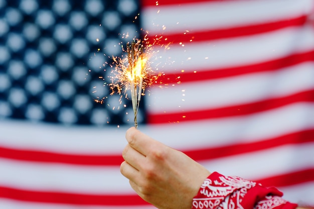 Bengal fire on the background of the flag of America