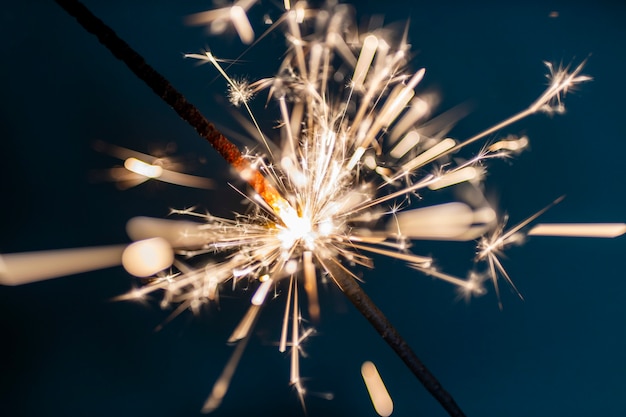 Bengal fire sparkles against the black background.