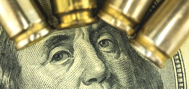 Benjamin franklin face with bullets, criminal money, diry
dollar concept banner background, close-up view photo