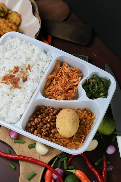 A bento box with rice, beans, and vegetables