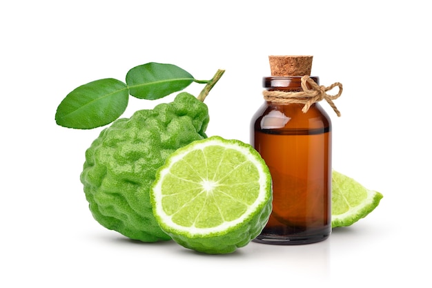 Bergamot essential oil extract in amber bottle with bergamot fruit isolated on white.