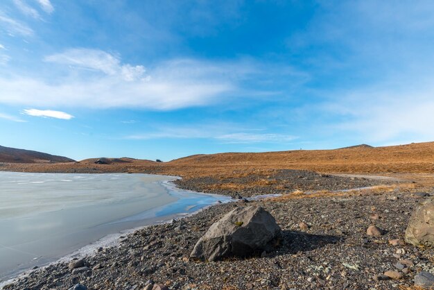 Bergen valleien bevroren meer en weide in de buurt van gletsjer in IJsland