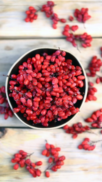 Berries and bunches of barberry in a bowl.