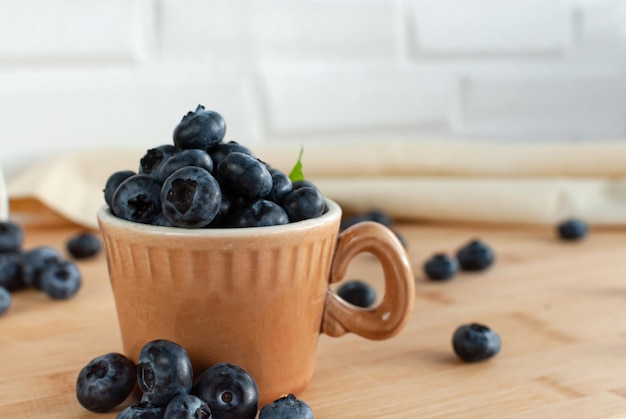 Berries of fresh blueberries in a cup Coffee cups Selective focus simple composition