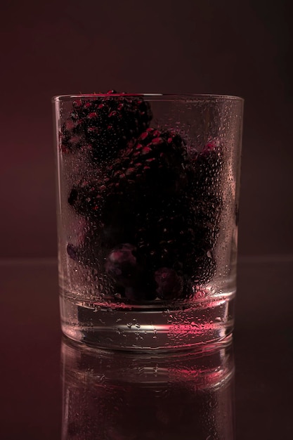 Berries in a glass. Blackberries and blueberries in a bowl on a dark background