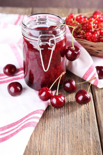 Berries jam in glass jar on table closeup