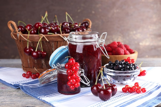 Berries jam in glass jar on table closeup