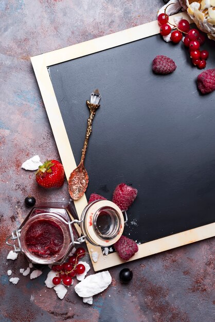 Berries jam in glass jar on table