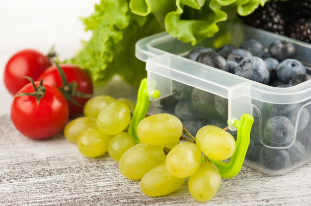 Berries in lunch box and fruits 