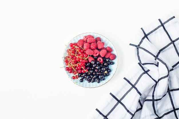 Berries on a plate on a white background