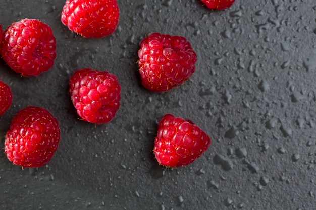 berries raspberry on black slate background