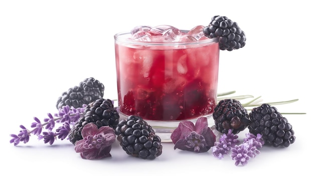 Berry drink with ice in a glass surrounded by blackberries and lavender