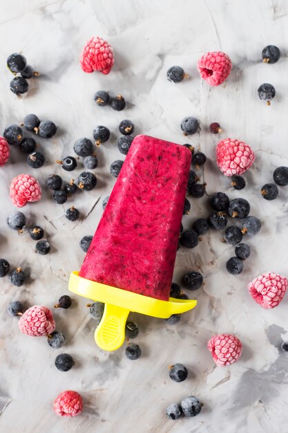 Berry ice cream on a stick of raspberries and currants