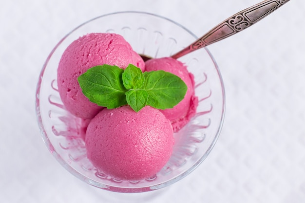 Berry ice cream on white fabric background, top view.