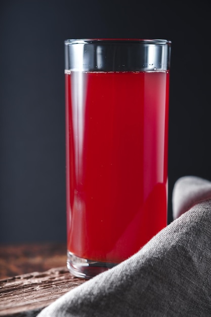 Photo berry juice on the wooden table vertical