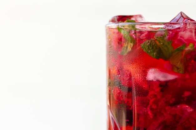 Berry lemonade with ice on white background