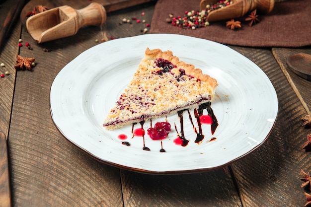 Berry pie decorated with chocolate sauce