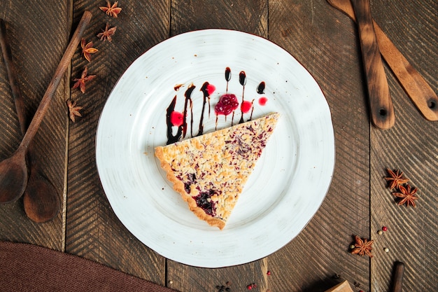 Berry pie decorated with chocolate sauce