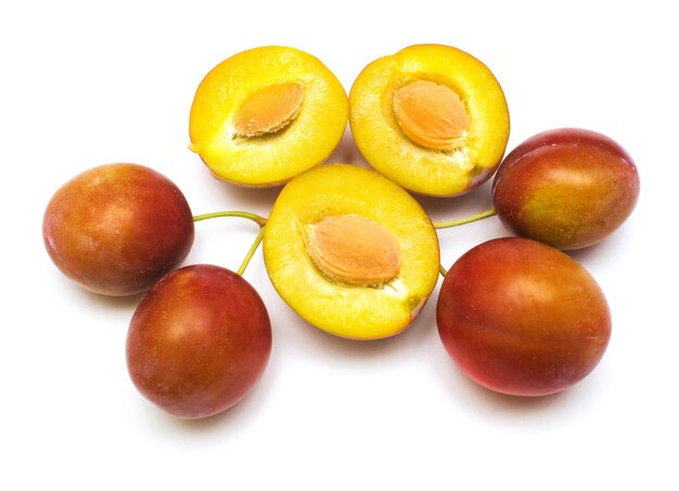 Berry plums with leaves isolated on white background. A useful fruit for health, vitamins. Flat lay, top view