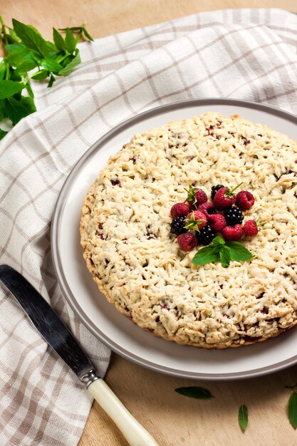 Berry shortcrust pie with crumble on a plate