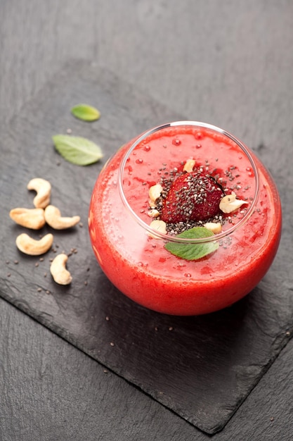 Berry smoothie with strawberries and cashew nuts Top view