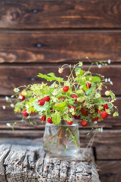 Bessenboeket in een glas op houten