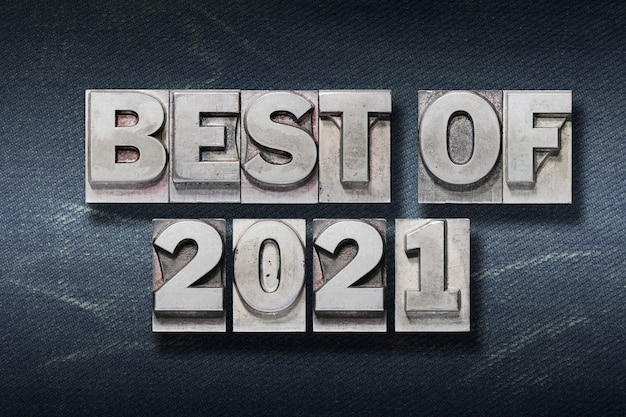 Best of 2021 year phrase made from metallic letterpress on dark jeans background