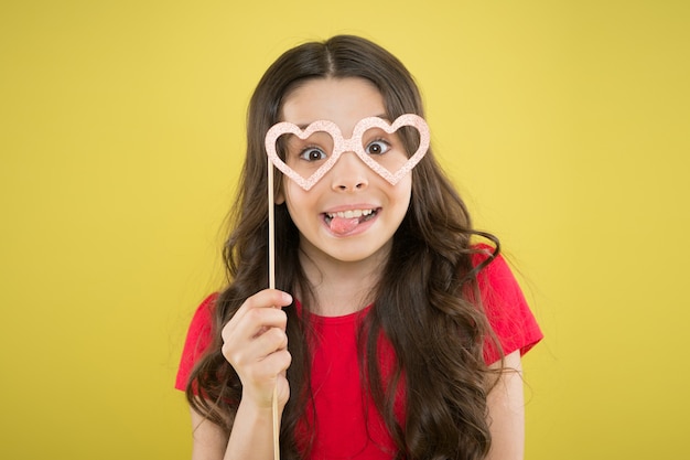 Best celebration. summer fashion. small girl with party glasses. small girl hold funny glasses. happy birthday. party elements. child ready for party. prepare for party. girl on yellow background.