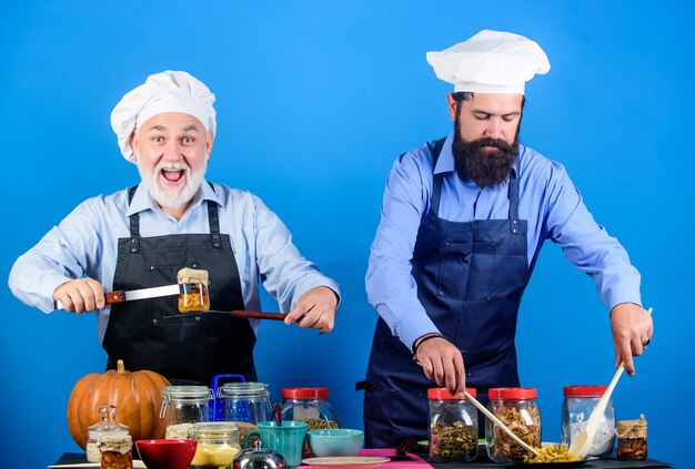 Best chef ever. Halloween pumpkin recipe. Healthy food cooking. mature senior bearded men in kitchen. cereals and seasoning. professional restaurant cook. Chef men cooking. cheerful men prepare food.