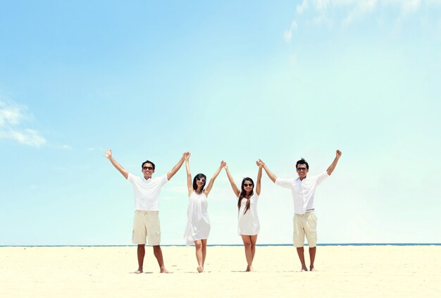Photo best friend in white together holding and raise each other hand