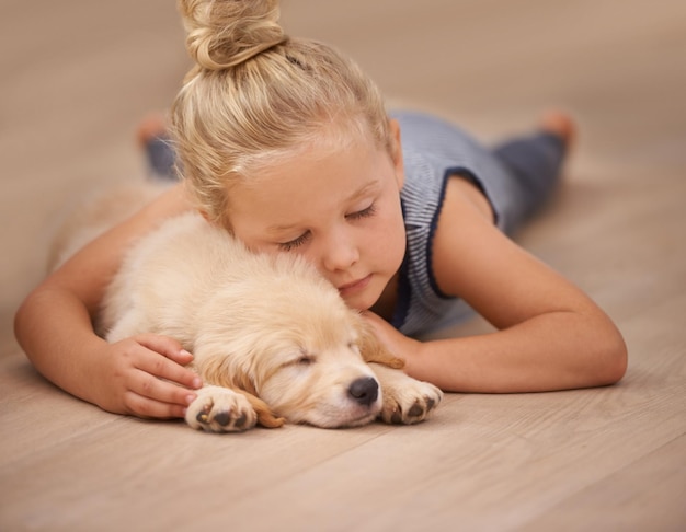 The best friend you can get An adorable little girl with her puppy at home