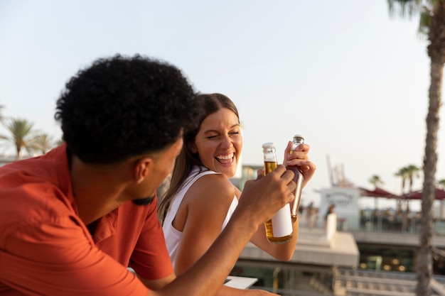 Best friends having a drink together outdoors