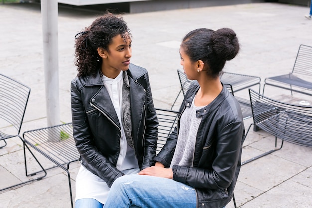 Best friends talking and having fun in park