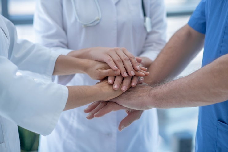 Photo best team. close-up of hospital team putting hands together