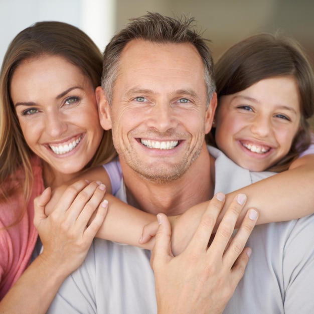 The best team hes ever rooted for A young girl with her parents spending time indoors