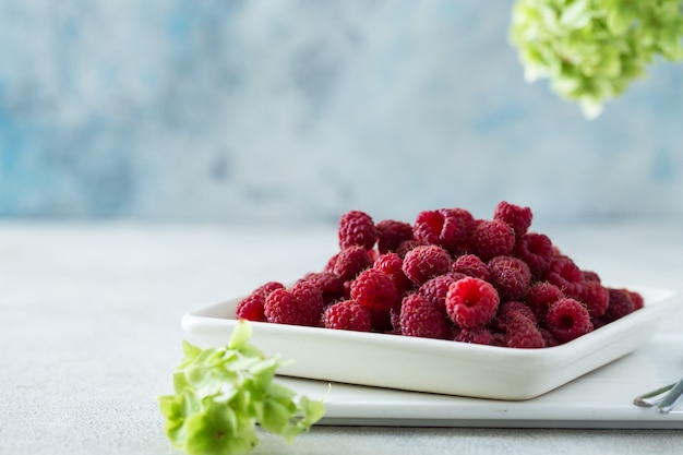 Bestrooide Frambozen op witte achtergrond. Rijpe frambozen met kopie ruimte voor tekst. Framboos op een witte achtergrond. Bovenaanzicht Diverse frisse zomervruchten. Achtergrond van frambozen.