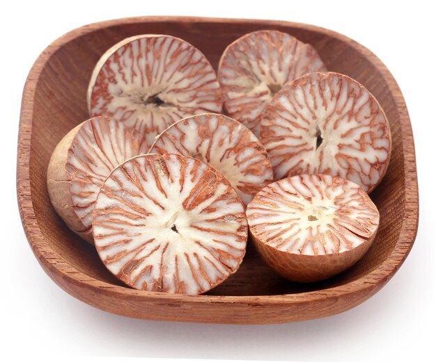 Betel nuts in a bowl over white background