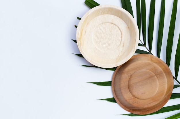 Betel palm leaf plates on white background.