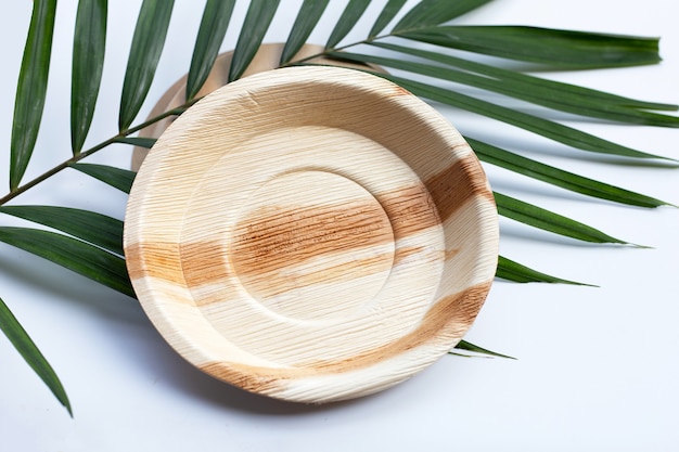 Betel palm leaf plates on white background.