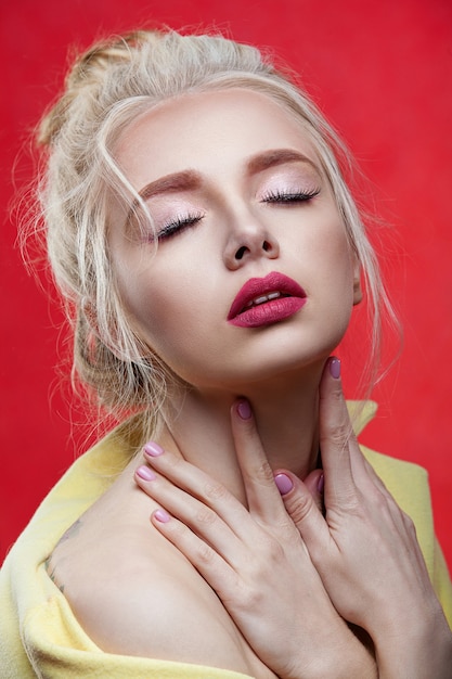 Beuty porter  girl with white hair on a red background. beautiful of hair and make-up.