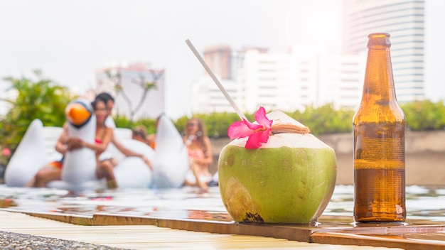 beverage and coconut juice with bottle of beer on pool 