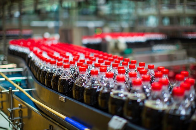 Beverage factory interior. Conveyor flowing with bottles for carbonated water.