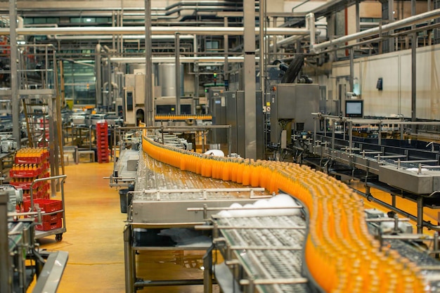 Beverage factory interior conveyor flowing with bottles for\
juice